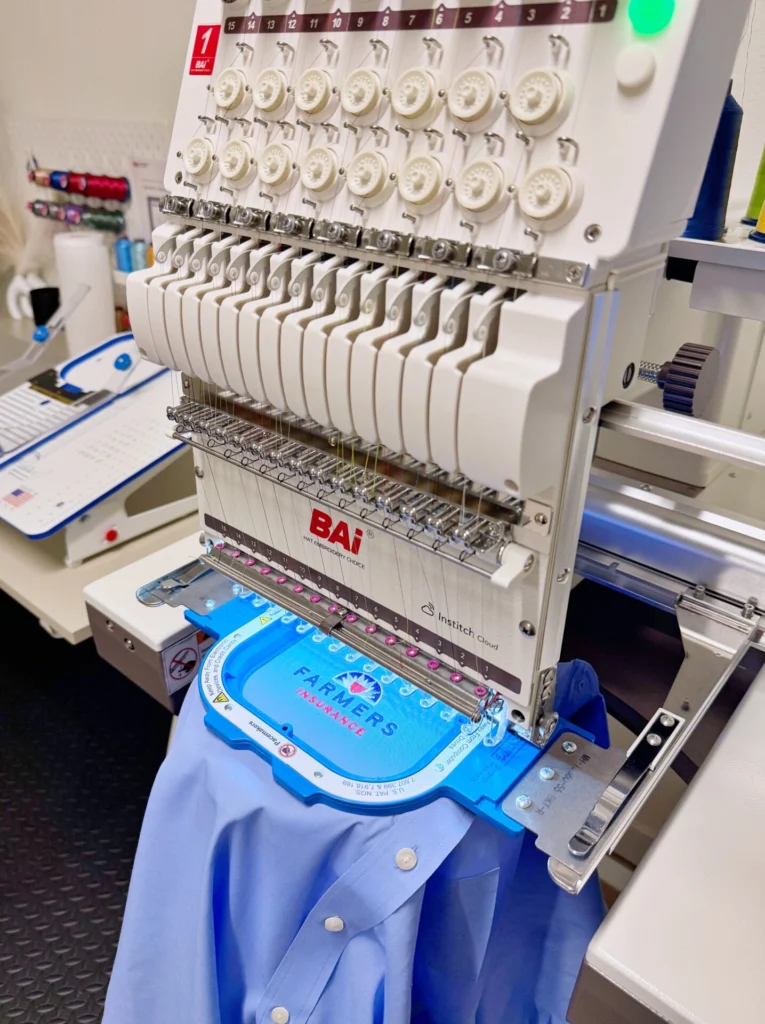 Work shirt hooped on Neatko’s multi-needle embroidery machine