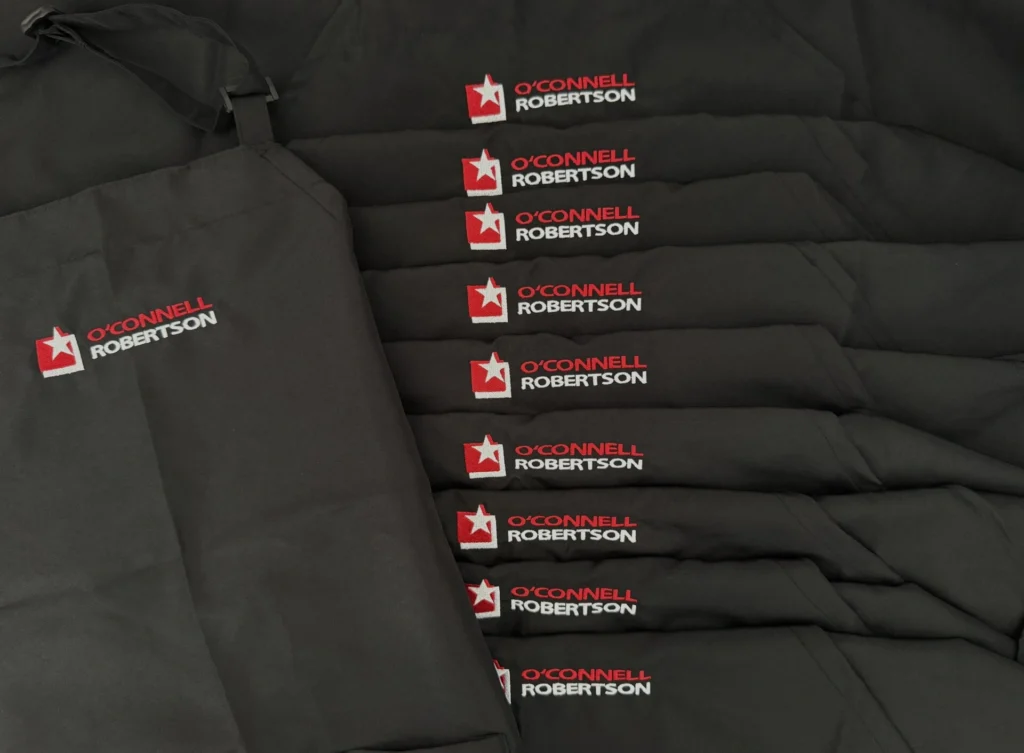 Black aprons with embroidered O’Connell Robertson logo